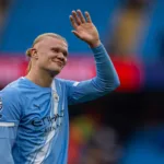 Grafika przedstawiająca machającego piłkarza.