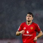 Grafika przedstawiająca piłkarza w deszczu.