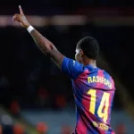 Grafika przedstawiająca piłkarza z ręką w górze.